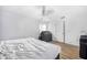 Bright bedroom featuring a bed with white linens and wood-look flooring at 7120 Summit Dr, Winter Haven, FL 33884