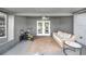 This covered patio includes direct access to the home, with comfortable seating and a peaceful space for relaxing at 7120 Summit Dr, Winter Haven, FL 33884