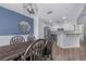 Dining room with a wooden table, a mirror on the wall, and access to the kitchen at 7120 Summit Dr, Winter Haven, FL 33884