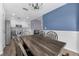 Open-concept dining area with a wooden table and a modern chandelier at 7120 Summit Dr, Winter Haven, FL 33884