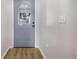 Entryway showcasing a blue front door with decorative glass and wood-look floors at 7120 Summit Dr, Winter Haven, FL 33884