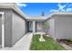 The front entrance to this home features a charming light blue door and a beautiful lawn space at 7120 Summit Dr, Winter Haven, FL 33884