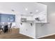Bright, open kitchen and dining area with white cabinets and stainless steel appliances at 7120 Summit Dr, Winter Haven, FL 33884