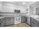 Well-lit kitchen features white cabinetry, stainless steel appliances, and a light countertop at 7120 Summit Dr, Winter Haven, FL 33884