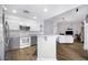 Open kitchen with stainless steel appliances and breakfast bar, connecting to living area at 7120 Summit Dr, Winter Haven, FL 33884