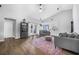 Open-concept living room featuring vaulted ceilings, wood flooring and a comfortable seating arrangement at 7120 Summit Dr, Winter Haven, FL 33884