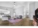 Open concept living room with vaulted ceiling and stylish decor with easy flow into the kitchen at 7120 Summit Dr, Winter Haven, FL 33884