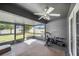 The screened patio includes an exercise area and a ceiling fan for added comfort, overlooking the fenced backyard at 7120 Summit Dr, Winter Haven, FL 33884
