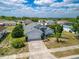 Birds eye view of a single story home with a grey roof, a 2-car garage, and modest landscaping at 799 Highland Crest Loop, Lake Wales, FL 33853