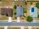 Overhead view of home with gray roof, basic landscaping, two neighboring homes and city street at 799 Highland Crest Loop, Lake Wales, FL 33853
