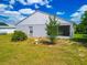 Rear exterior view of home showing the screened lanai, bird bath and minimal backyard landscaping at 799 Highland Crest Loop, Lake Wales, FL 33853