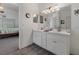 Bright bathroom featuring a double vanity, large mirror and views into the main bedroom at 799 Highland Crest Loop, Lake Wales, FL 33853