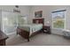 Cozy bedroom with plush carpet, slider to patio, and a window at 799 Highland Crest Loop, Lake Wales, FL 33853