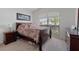 Bright bedroom with neutral carpet, a picture window and double bed at 799 Highland Crest Loop, Lake Wales, FL 33853