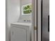 Small laundry area with white dryer and a window that lets in natural light at 799 Highland Crest Loop, Lake Wales, FL 33853