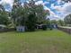 Sprawling backyard showcasing shed, greenery, and fencing at 803 7Th Ne St, Fort Meade, FL 33841