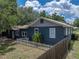 Landscaped backyard featuring a white picket fence, mature trees, and privacy fencing at 803 7Th Ne St, Fort Meade, FL 33841