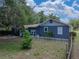 Landscaped backyard featuring a white picket fence, mature trees, and an inviting atmosphere at 803 7Th Ne St, Fort Meade, FL 33841