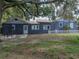 Backyard featuring mature trees, privacy fencing, and lush green grass at 803 7Th Ne St, Fort Meade, FL 33841