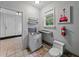 Compact bathroom features a stainless steel sink, window, and quirky decor at 803 7Th Ne St, Fort Meade, FL 33841