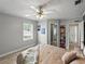 Bright bedroom featuring wood floors, a ceiling fan, and a built-in bookshelf at 803 7Th Ne St, Fort Meade, FL 33841