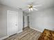 Bedroom featuring wood floors, a ceiling fan, and two doors at 803 7Th Ne St, Fort Meade, FL 33841