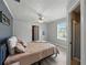 Comfortable bedroom featuring wood floors, a ceiling fan, and a window offering natural light at 803 7Th Ne St, Fort Meade, FL 33841