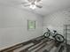 Spare bedroom with modern wood flooring, ceiling fan, and a large window at 803 7Th Ne St, Fort Meade, FL 33841