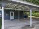 Carport area with a covered roof and access to the side entrance of the house at 803 7Th Ne St, Fort Meade, FL 33841