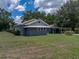 Charming home with well-manicured front lawn, covered parking, and a fenced backyard at 803 7Th Ne St, Fort Meade, FL 33841