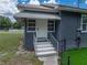 Inviting front entrance with freshly painted steps and railings leading to a classic front door at 803 7Th Ne St, Fort Meade, FL 33841