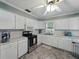 Kitchen showcasing stainless steel appliances, ample cabinet space, and a ceiling fan at 803 7Th Ne St, Fort Meade, FL 33841