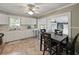 Bright kitchen with white cabinets, stainless appliances, and an adjacent dining area at 803 7Th Ne St, Fort Meade, FL 33841