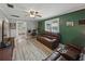 Living room featuring leather furniture, wood floors, and a bright window at 803 7Th Ne St, Fort Meade, FL 33841