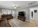 Open-concept living room featuring modern flooring, a large TV, and comfortable seating at 803 7Th Ne St, Fort Meade, FL 33841