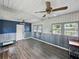 Bright sitting room with unique wainscotting and lots of natural light from surrounding windows at 803 7Th Ne St, Fort Meade, FL 33841