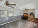 Sunroom shows lots of natural light, unique half-wall paneling, and a view into the kitchen at 803 7Th Ne St, Fort Meade, FL 33841