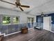 Sitting area with lots of natural light, unique paneling, and wood-like flooring at 803 7Th Ne St, Fort Meade, FL 33841