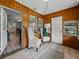 Inviting sunroom with wood paneling, stylish furniture, and an abundance of natural light at 803 7Th Ne St, Fort Meade, FL 33841