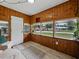 Bright sunroom with wood paneling, large windows, and modern flooring with lots of natural light at 803 7Th Ne St, Fort Meade, FL 33841