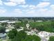 Aerial view showcasing the property's location within a lush, green neighborhood on a sunny day at 808 Ware Ne Ave, Winter Haven, FL 33881