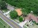 Aerial view showcases the home and surrounding neighborhood in a lush, green setting at 808 Ware Ne Ave, Winter Haven, FL 33881