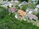 Aerial view of a well-maintained single-Gathering home featuring a brown roof and a spacious yard with storage sheds at 808 Ware Ne Ave, Winter Haven, FL 33881