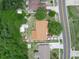 Aerial view of home with brown roof, showcasing the property's layout, surrounding trees, proximity to street, and parking at 808 Ware Ne Ave, Winter Haven, FL 33881