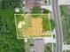Aerial view of the property showcasing its backyard, shed, and proximity to the road at 808 Ware Ne Ave, Winter Haven, FL 33881