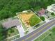 Aerial view showing the house with driveway parking surrounded by green foliage at 808 Ware Ne Ave, Winter Haven, FL 33881