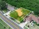 Aerial view highlighting the property with its fenced yard and surrounding landscape at 808 Ware Ne Ave, Winter Haven, FL 33881