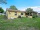Exterior view of the backyard with a screened-in porch that offers a serene and private outdoor living space at 808 Ware Ne Ave, Winter Haven, FL 33881
