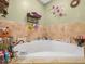 Bright bathroom featuring a soaking tub with decorative wall accents and tile surround at 808 Ware Ne Ave, Winter Haven, FL 33881