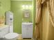 Bathroom featuring a white vanity, wall mirror, and gold shower curtain at 808 Ware Ne Ave, Winter Haven, FL 33881